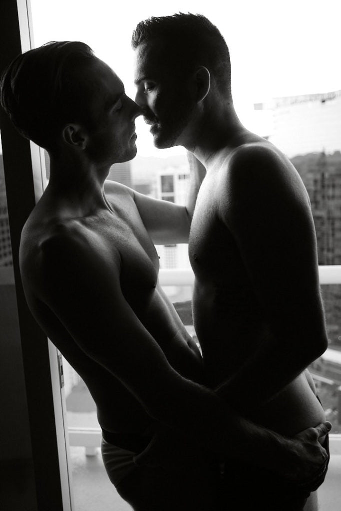 LGBTQIA+ couples boudoir session topless couple with underwear black and white photo toronto boudoir