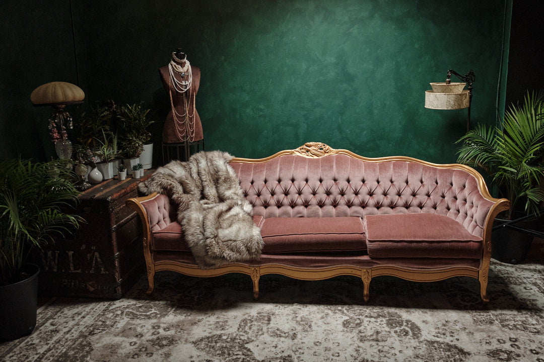 Lush greenery plants green wall pink couch luxurious furs pearls in Toronto Boudoir Photography studio